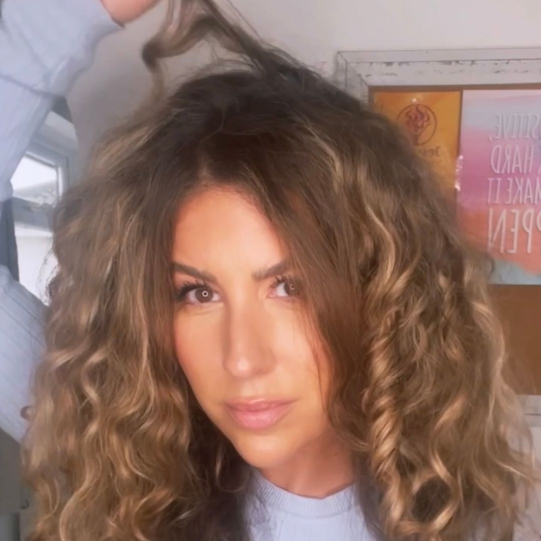 Chief Educator Claire showing off pieces of halo frizz in her own hair