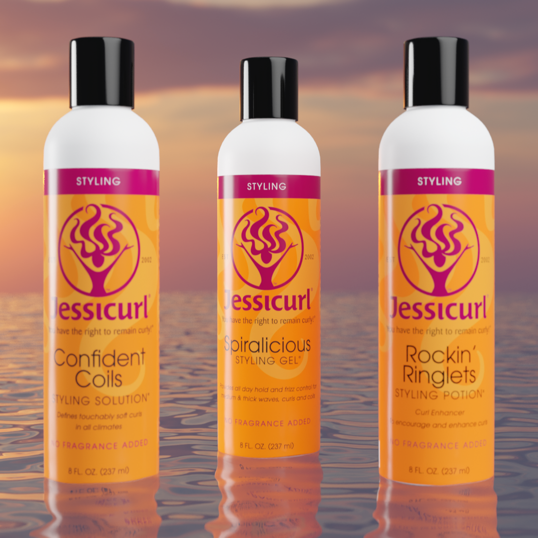 Jessicurl's Confident Coils, Spiralicious Styling Gel, and Rockin Ringlets sitting on top of water at sunset