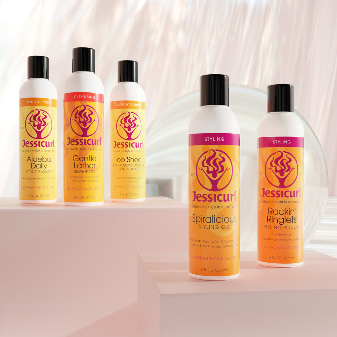 8oz Jessicurl Stylers and Cleansers on display on pink stands with a reflective pink background