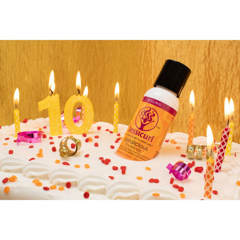 Spiralicious bottle on cake with lit candles and sprinkles