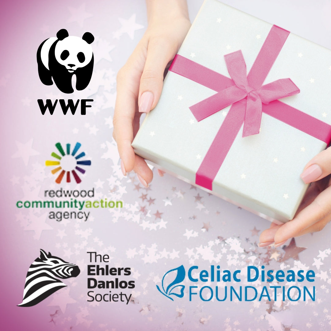 close up of woman holding a box with a ribbon with logos of charities around the box