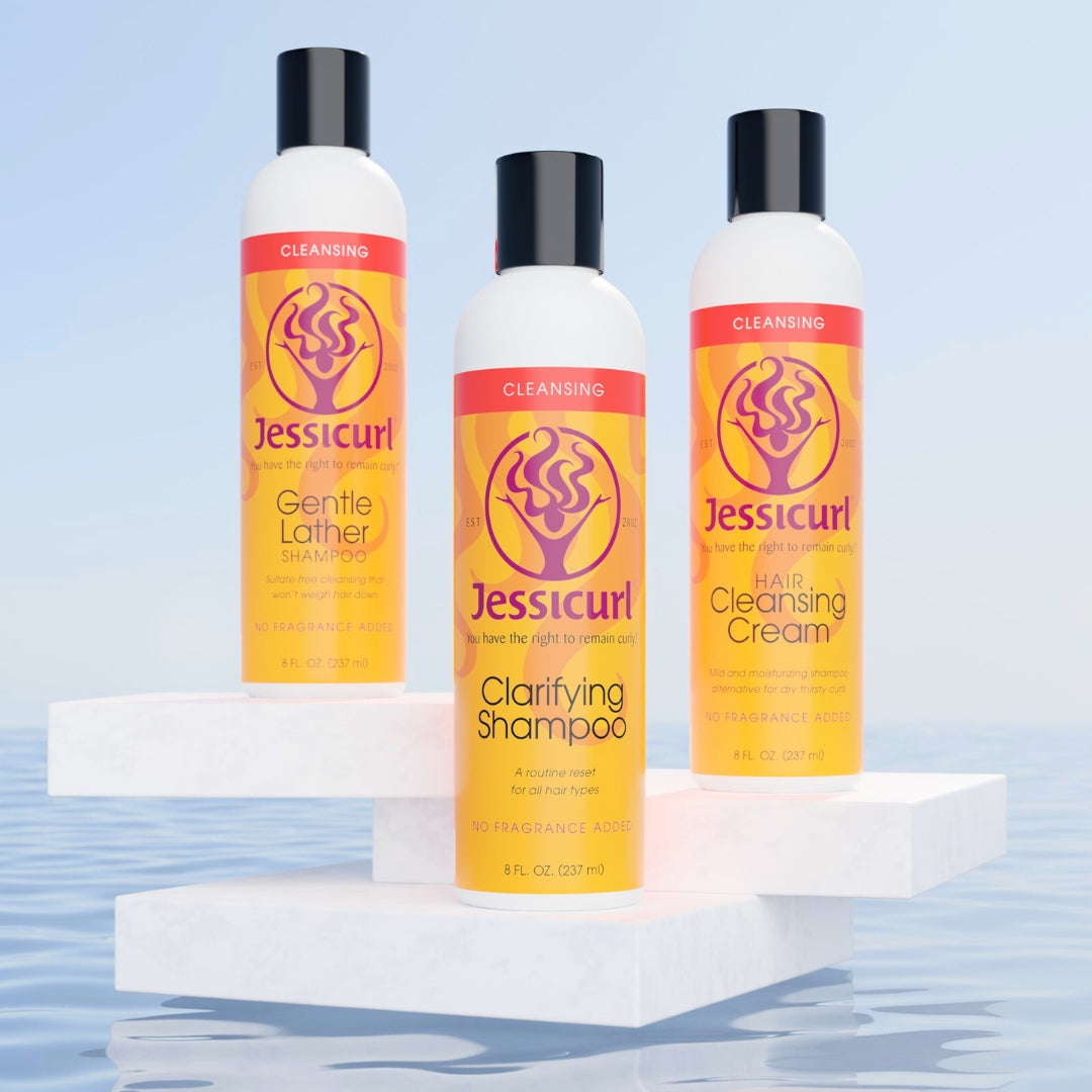 Jessicurl's three Cleansers sitting on a white pedestal above the water