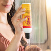 Woman pouring Hair Cleansing Cream into hand in shower.